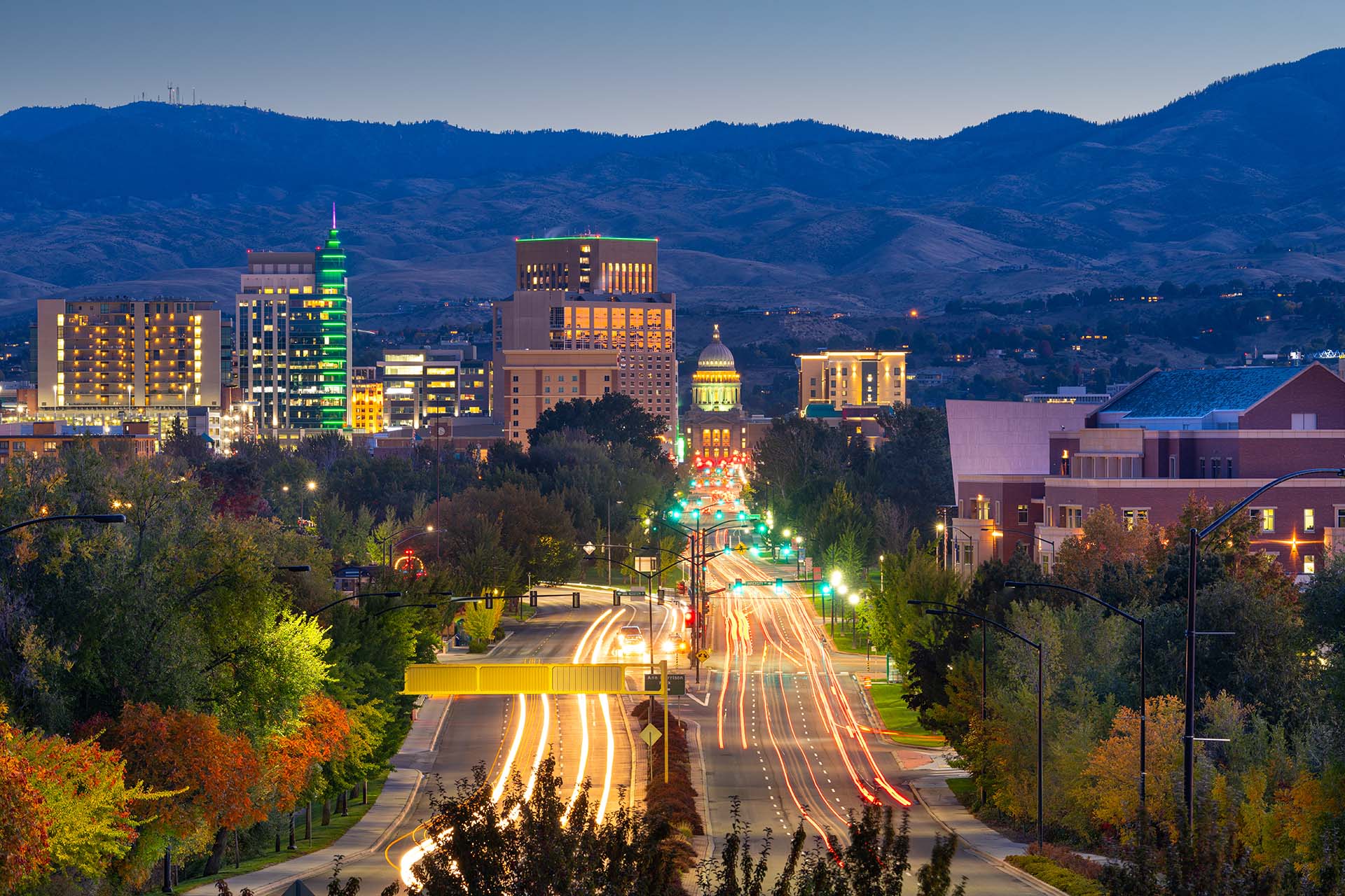 The city of Boise ID at dusk showing the lights of the city backdropped by the Boise foothills, a great place to live in 55 and older communities