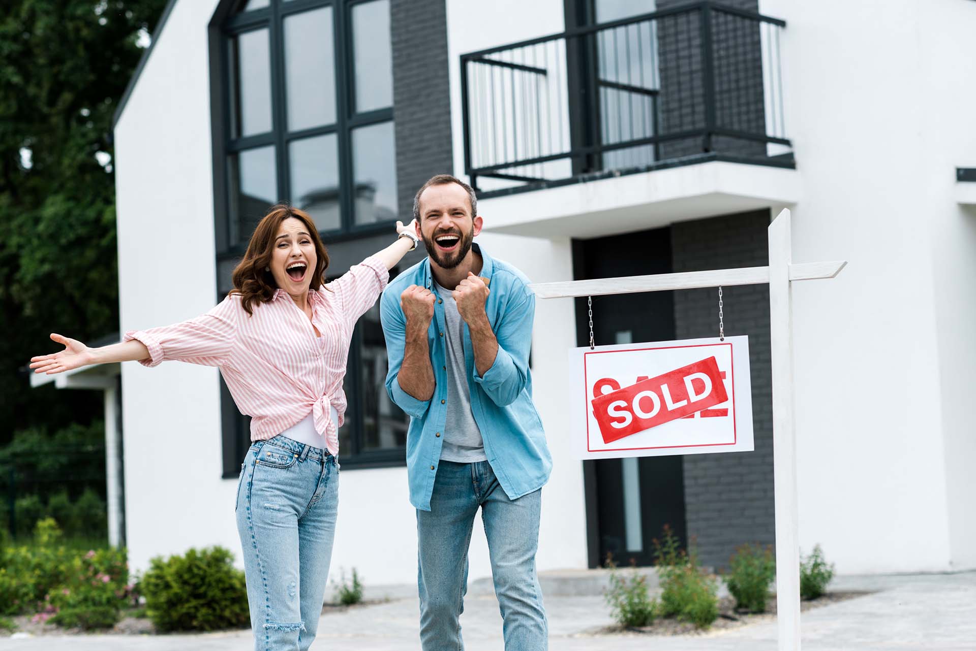 Excited couple who just sold their home for top dollar in difficult market conditions with a great realtor in North End, Boise.