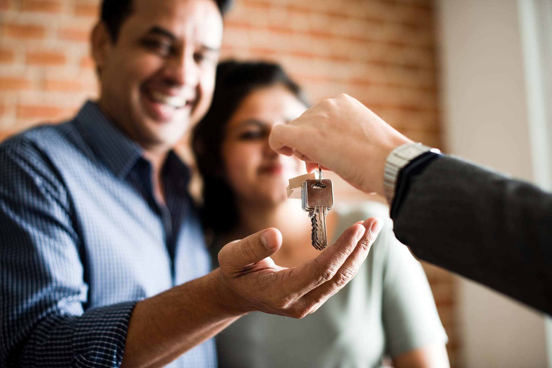 Excited couple receives the keys to their new home in Meridian Local real estate agents and realtors are ideal when selling your house or in the home buying process.