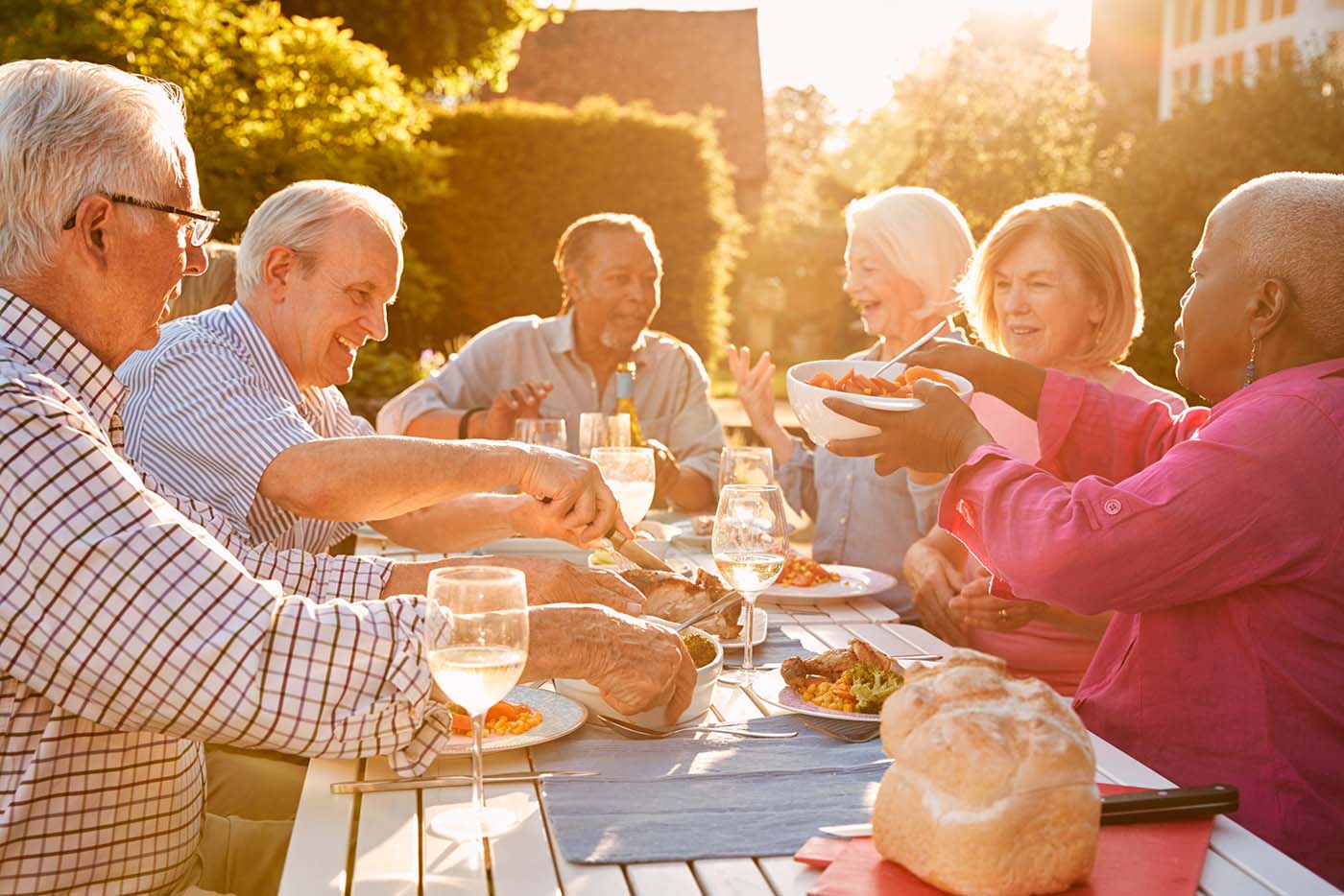 Residents of a 55 plus community having a dinner party after buying their new single level homes in the mild climate of the Treasure Valley
