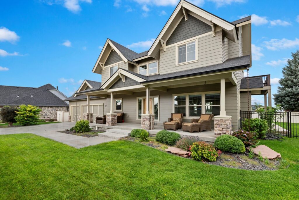 Charming two-story South Nampa home. Hardwood floors, grand staircase, and a luxury primary suite near Red Hawk Golf.